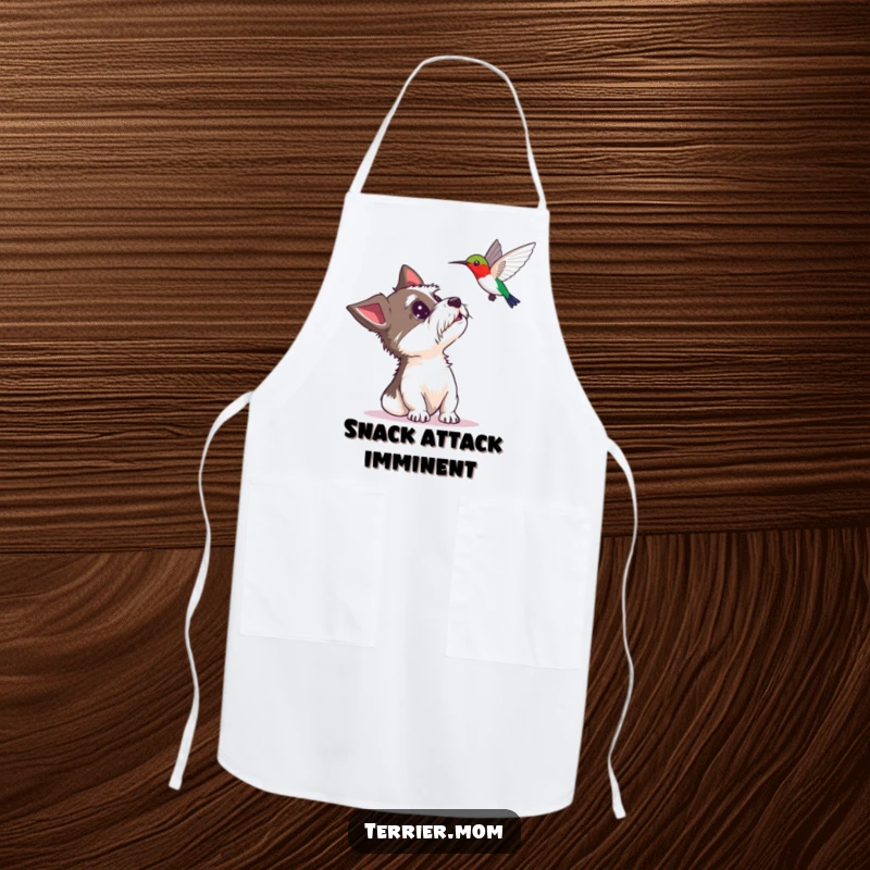 Funny apron showing a terrier looking up with delighted surprise at a hovering hummingbird, practical kitchen wear with a humorous touch.