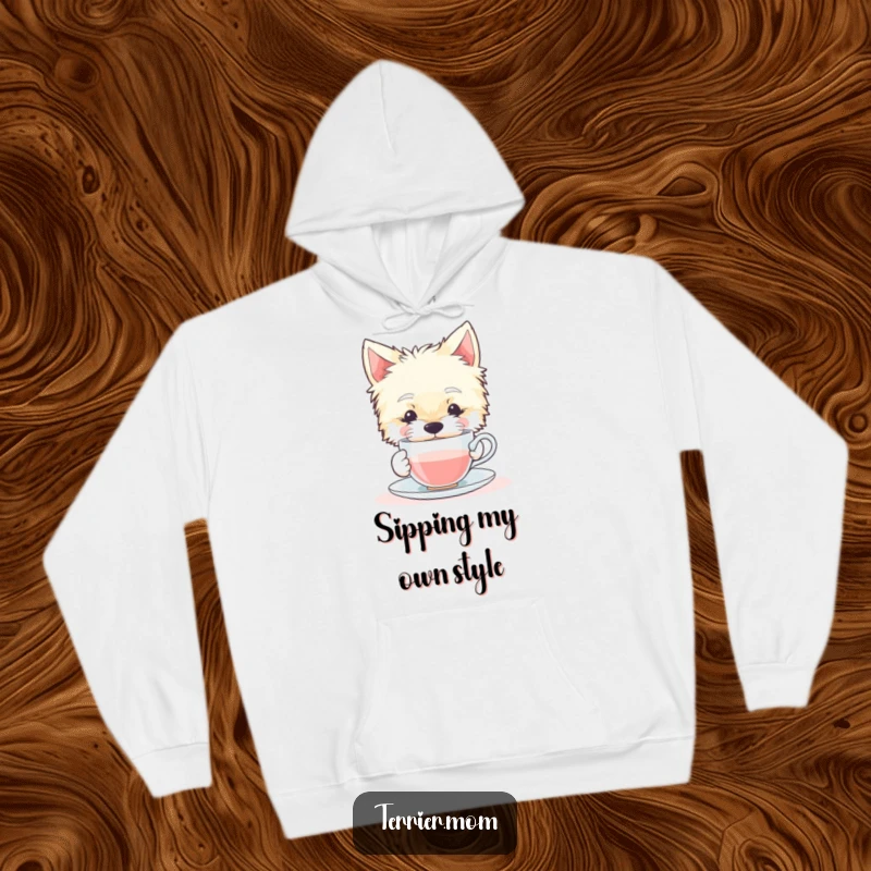Funny hoodie featuring a tranquil Terrier dog gracefully sipping from a tiny teacup, perfect for cozy relaxation.