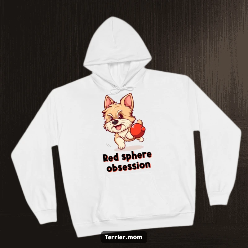 Funny hoodie showing a scruffy dog with alert ears excitedly chasing a round red object.