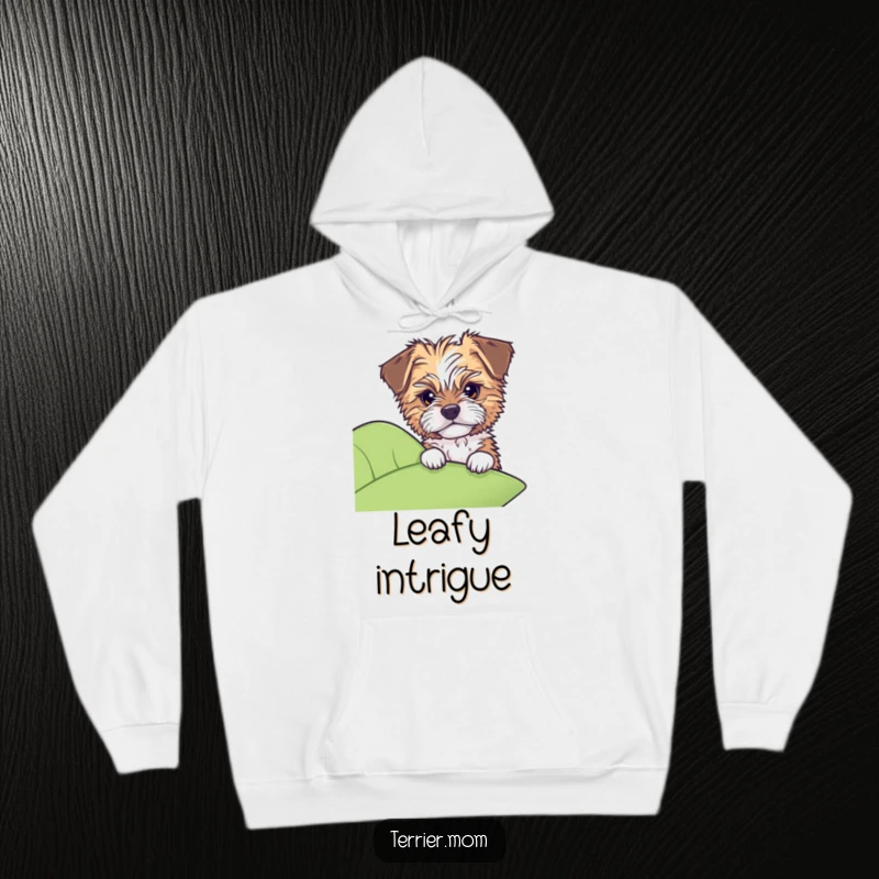 Funny hoodie showing a tousled dog peeking with gentle curiosity from behind a large green leaf.