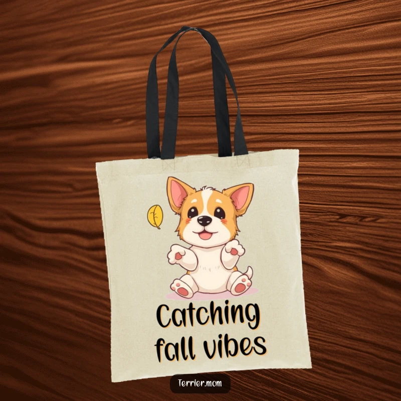 Funny Terrier Tote Bag: A playful terrier with outstretched paws attempts to catch a falling leaf, a humorous and practical accessory.