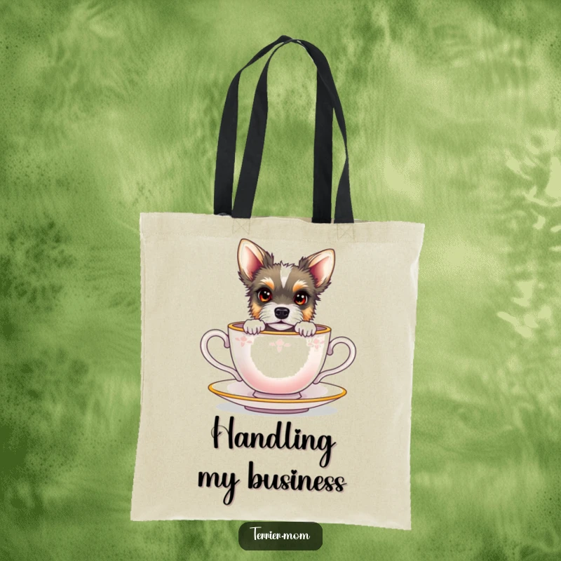 Funny terrier with bright eyes peeking out from a miniature teacup, on a reusable canvas tote bag.